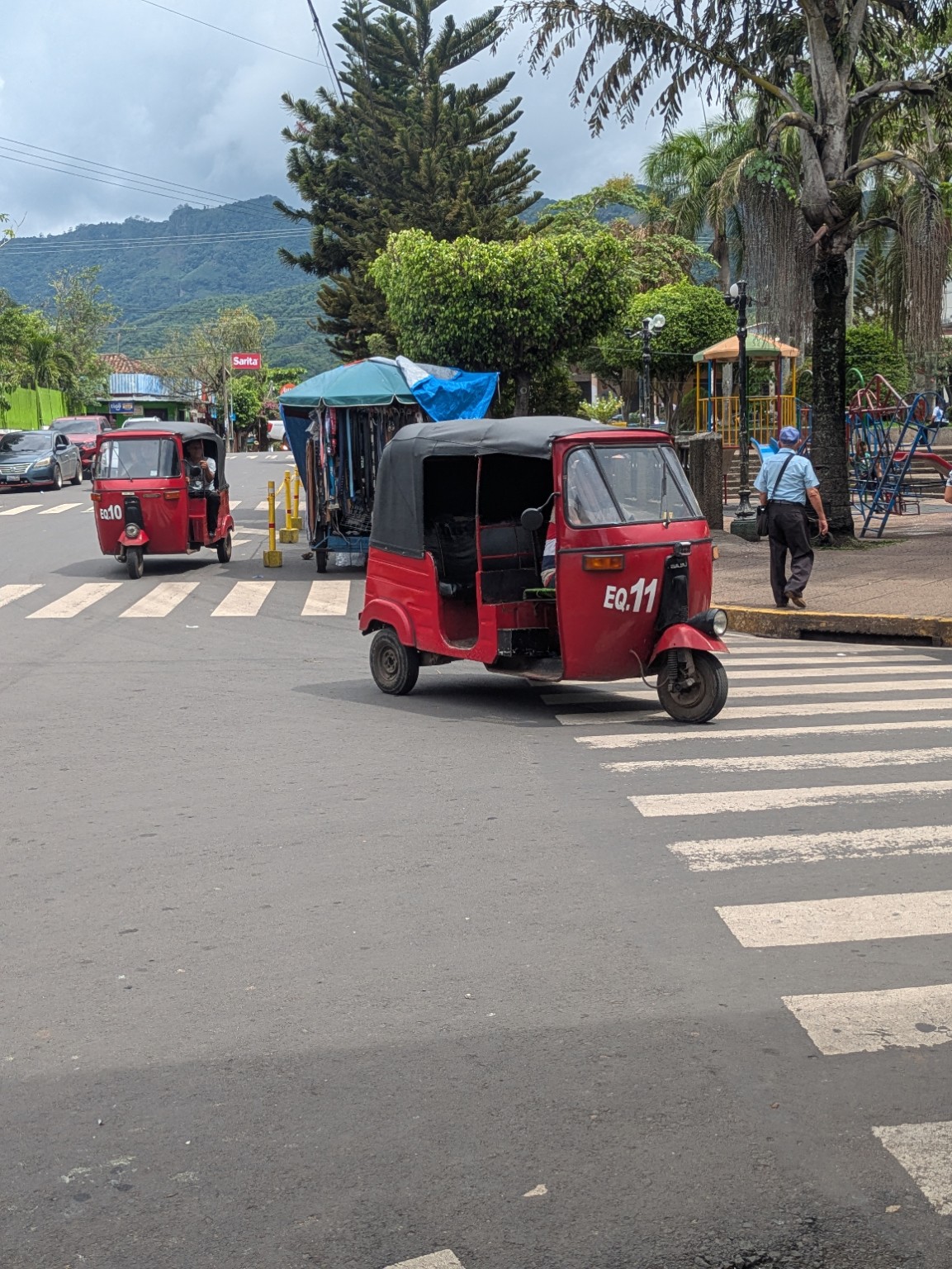 Red tuk-tuk in a local El Salvador town